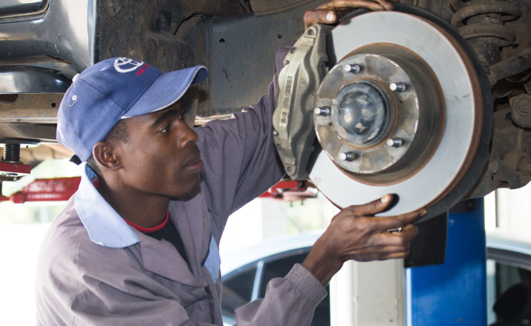 Technician working on a vehicle wheel and brake